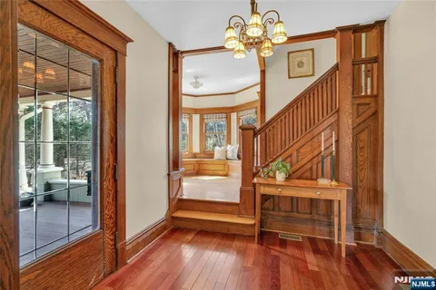 a view of entryway and hall with wooden floor