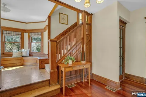 a view of an entryway with wooden floor and door