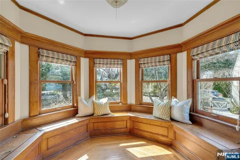 a living room with furniture and large windows