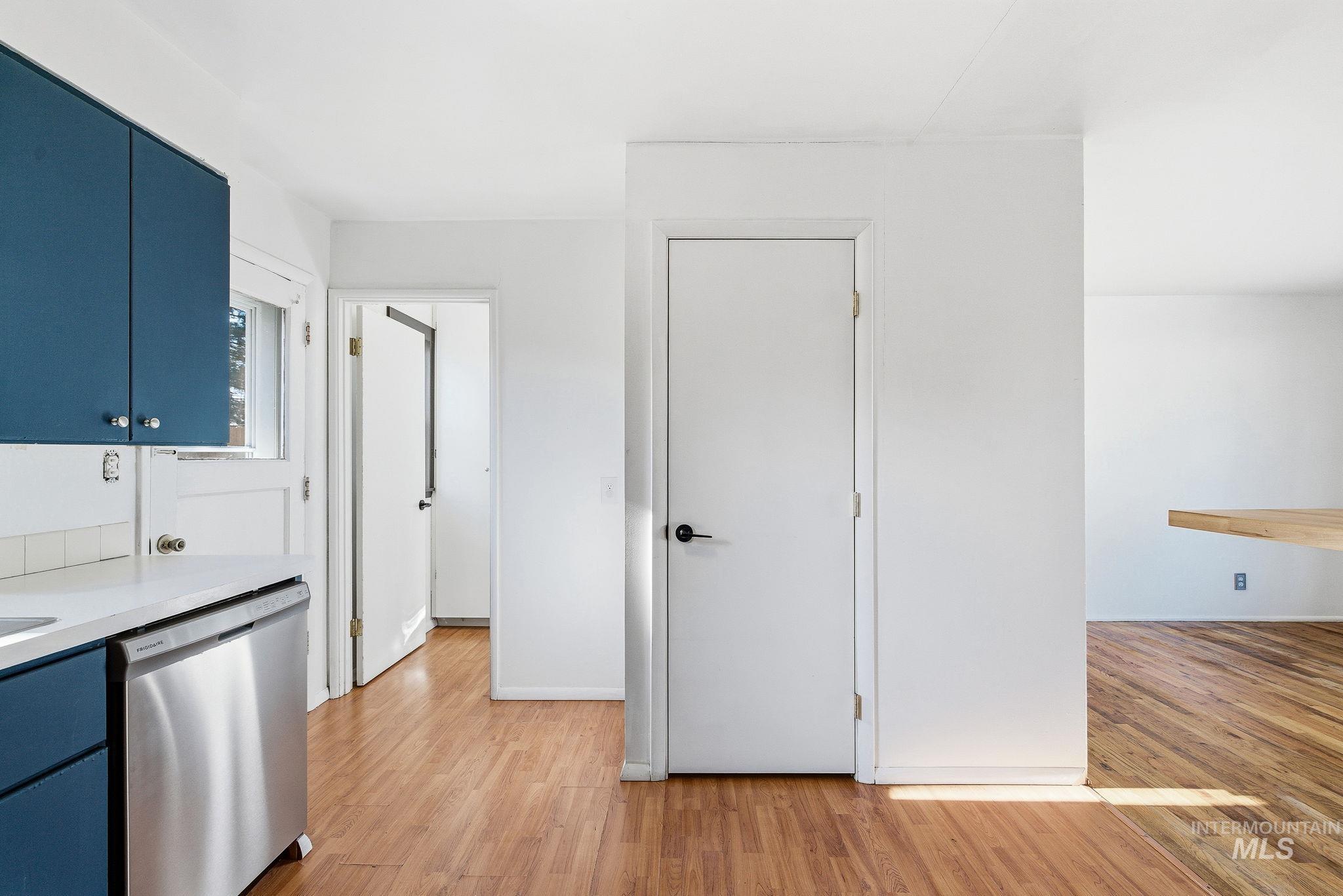 5603 West Edson Street Boise, ID 83705 - Photo 22 of 43 Kitchen featuring blue cabinets, dishwasher, and light wood-type flooring