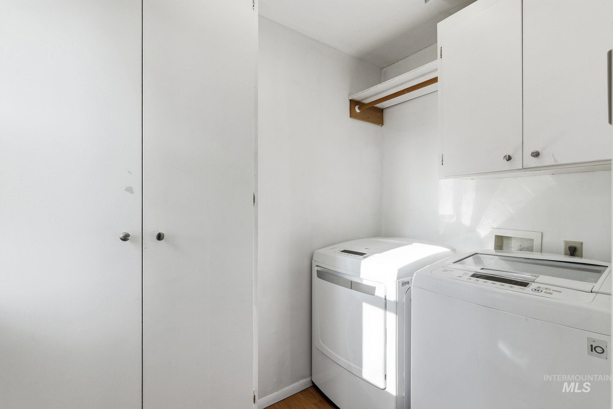 5603 West Edson Street Boise, ID 83705 - Photo 23 of 43 Washroom with washing machine and dryer, cabinet space, and light wood-style flooring