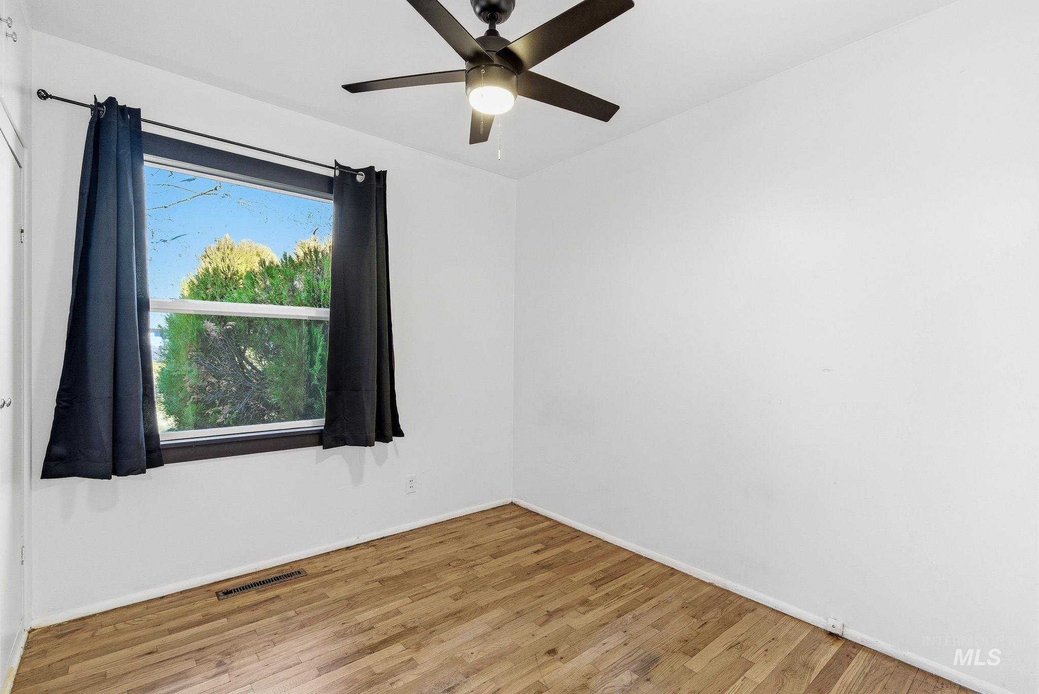 5603 West Edson Street Boise, ID 83705 - Photo 25 of 43 Empty room featuring hardwood / wood-style flooring and a ceiling fan