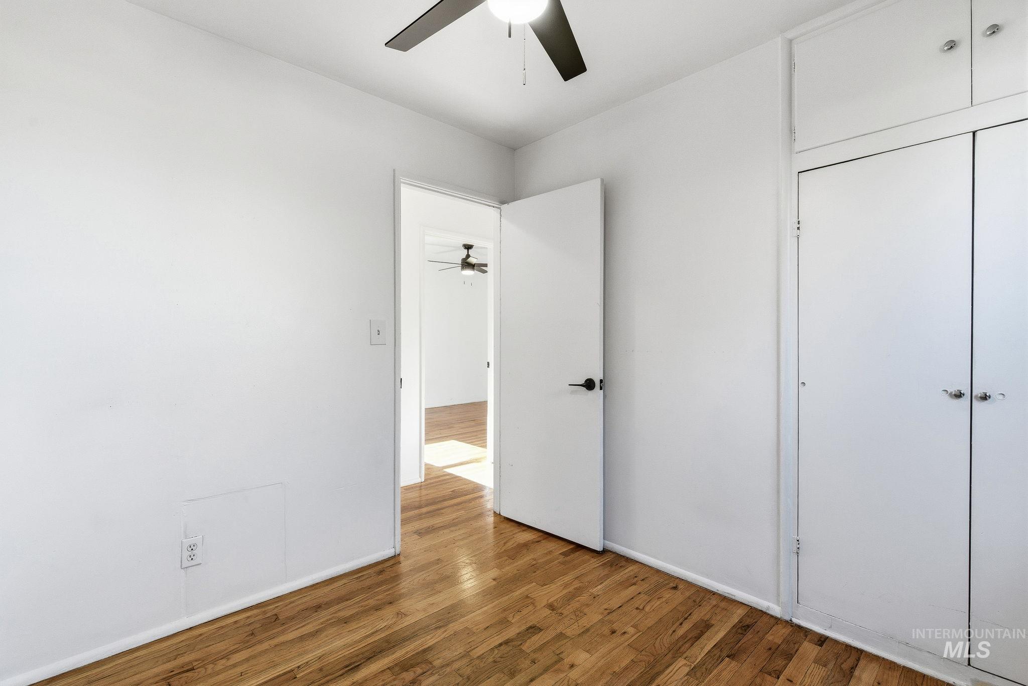 5603 West Edson Street Boise, ID 83705 - Photo 26 of 43 Unfurnished bedroom with wood finished floors, a closet, and ceiling fan