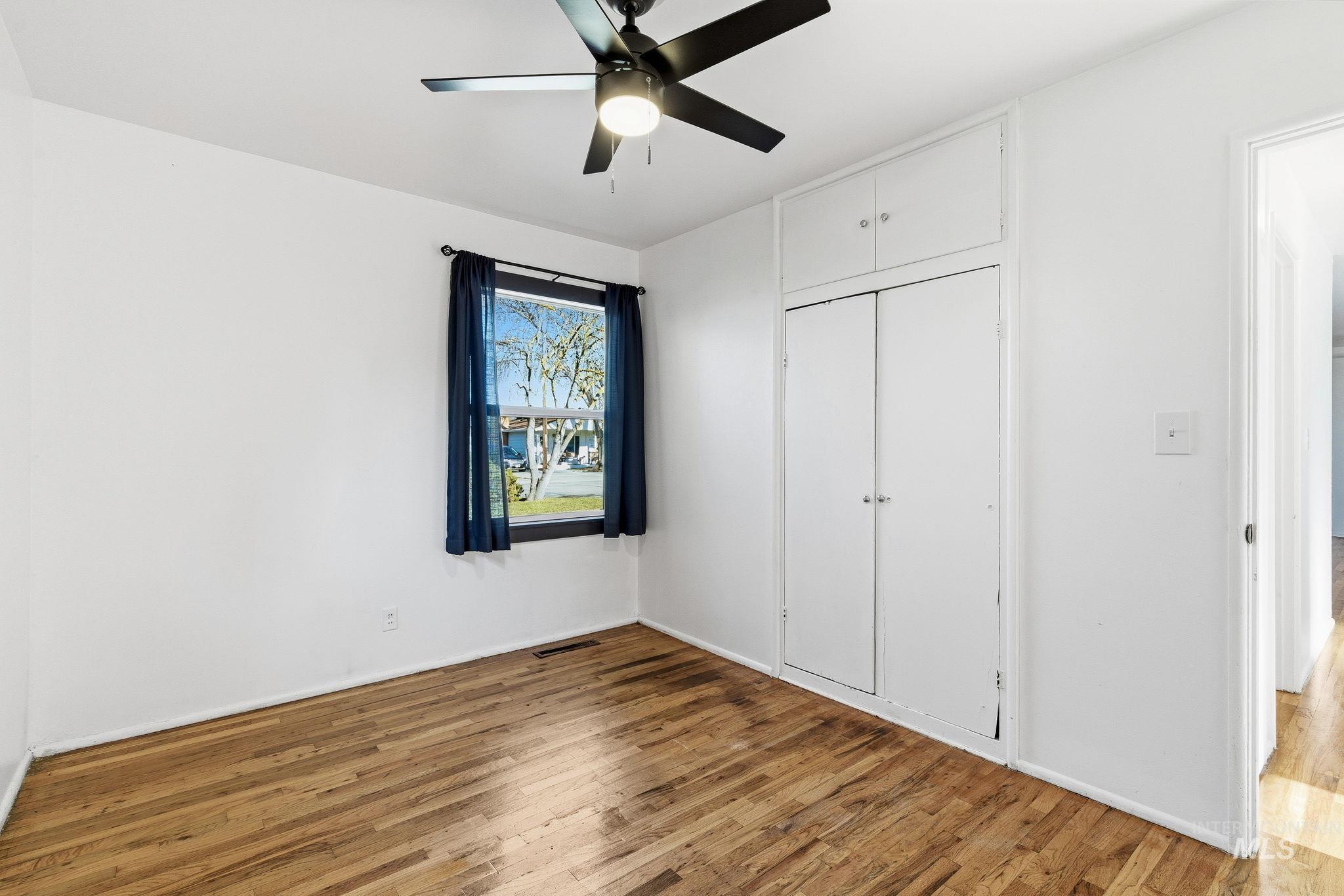 5603 West Edson Street Boise, ID 83705 - Photo 28 of 43 Unfurnished bedroom with hardwood / wood-style flooring, a closet, and a ceiling fan