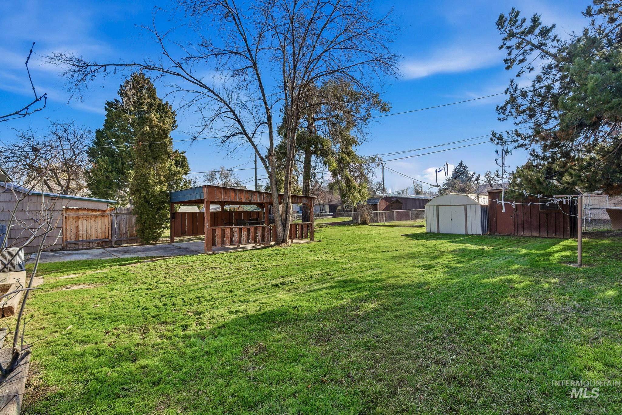 5603 West Edson Street Boise, ID 83705 - Photo 32 of 43 Fenced backyard featuring a storage unit