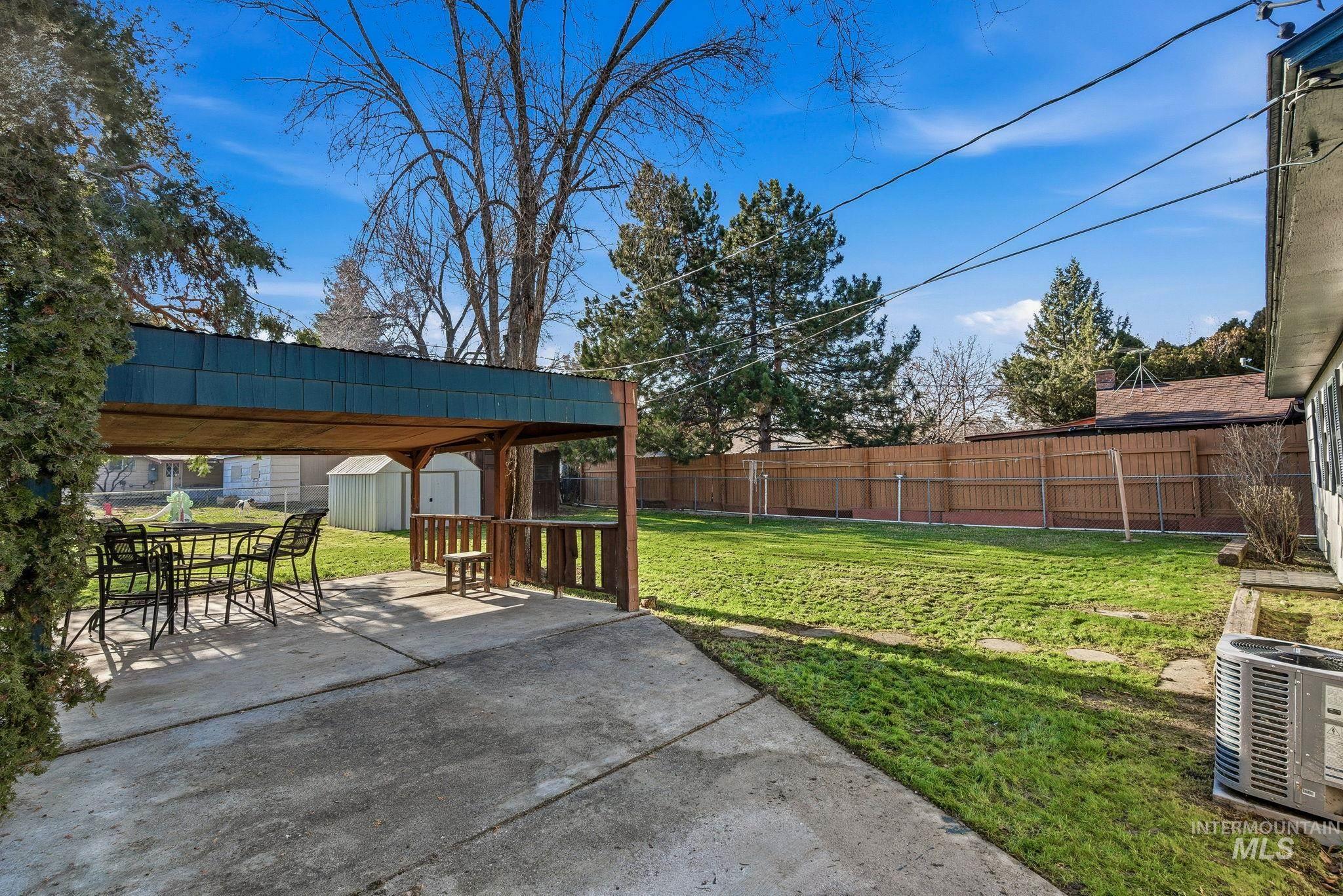 5603 West Edson Street Boise, ID 83705 - Photo 33 of 43 Fenced backyard with a storage shed, a patio, and outdoor dining space