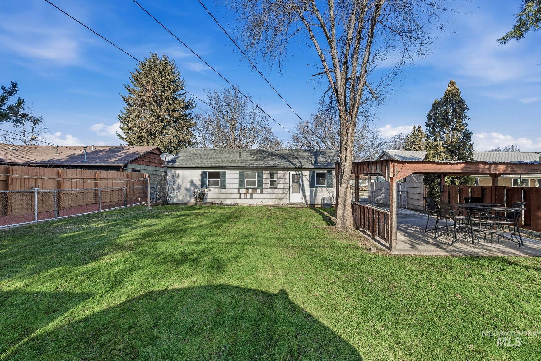 5603 West Edson Street Boise, ID 83705 - Photo 34 of 43 Rear view of property featuring a fenced backyard, a gazebo, and a patio