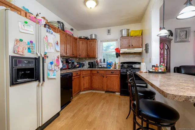 a kitchen with stainless steel appliances granite countertop a stove a sink and a refrigerator