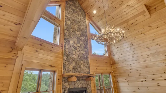 a view of a hallway with wooden floor and a kitchen