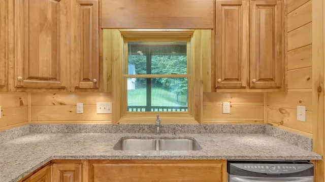 a bedroom with a bed and a flat tv screen on dresser