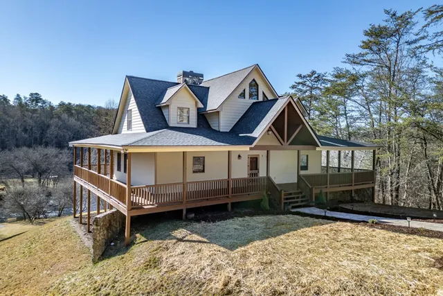 a front view of a house with a yard and wooden fence