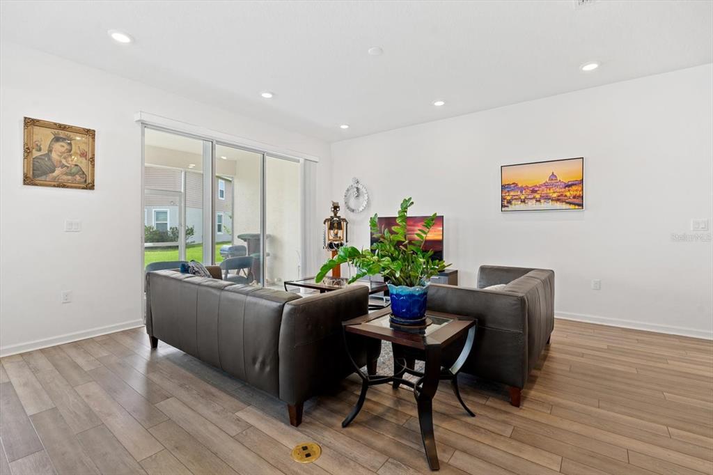 33 Ridge Road Palm Coast, FL 32137 - Photo 12 of 31 a living room with furniture and a potted plant
