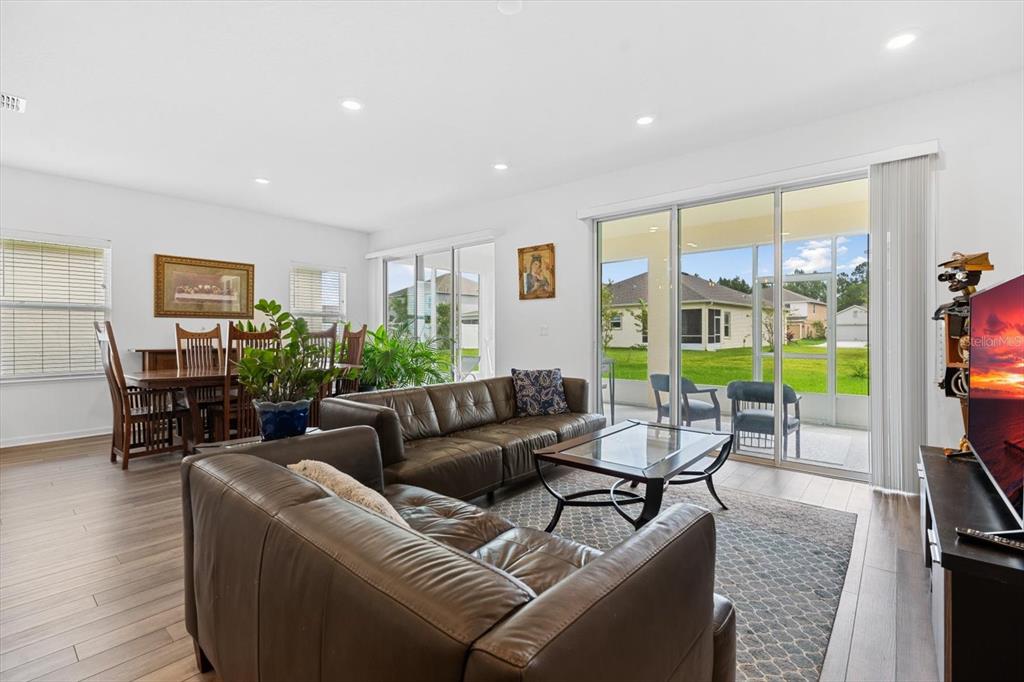 33 Ridge Road Palm Coast, FL 32137 - Photo 13 of 31 a living room with furniture and a floor to ceiling window