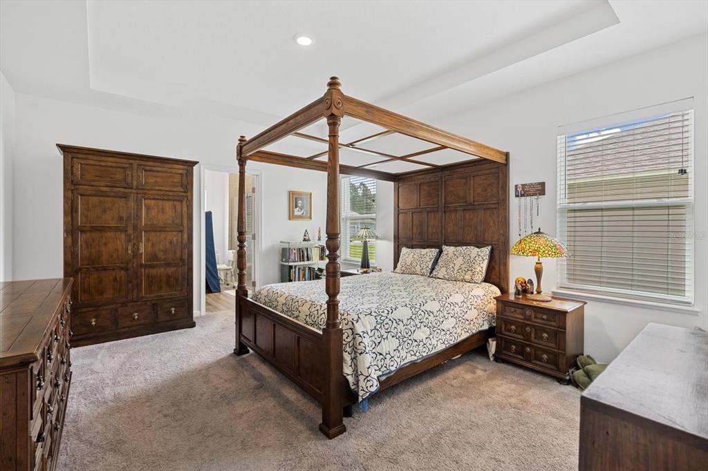 33 Ridge Road Palm Coast, FL 32137 - Photo 14 of 31 a bedroom with a bed a dresser and windows