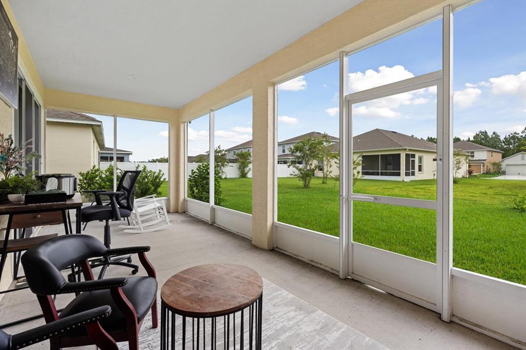 33 Ridge Road Palm Coast, FL 32137 - Photo 17 of 31 a view of a porch with furniture and yard