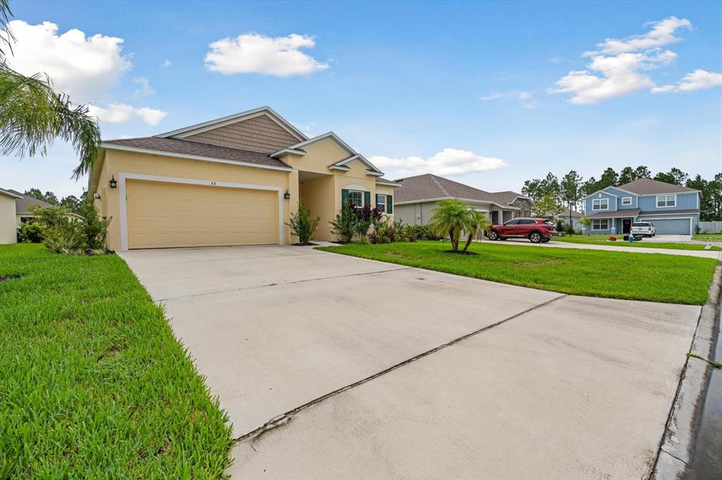 33 Ridge Road Palm Coast, FL 32137 - Photo 20 of 31 a front view of a house with a yard and garage