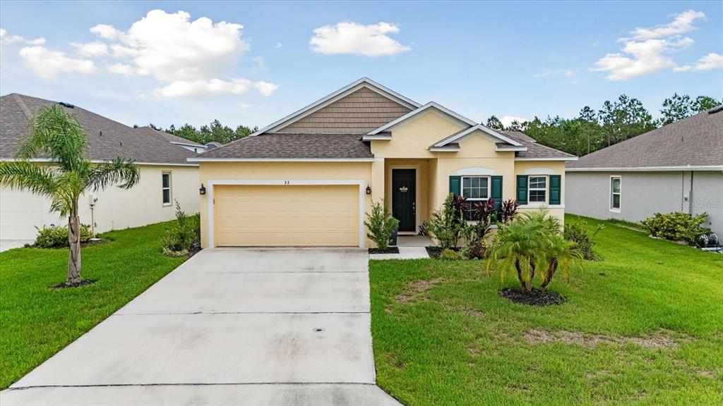 33 Ridge Road Palm Coast, FL 32137 - Photo 2 of 31 a view of a house with a yard and plants