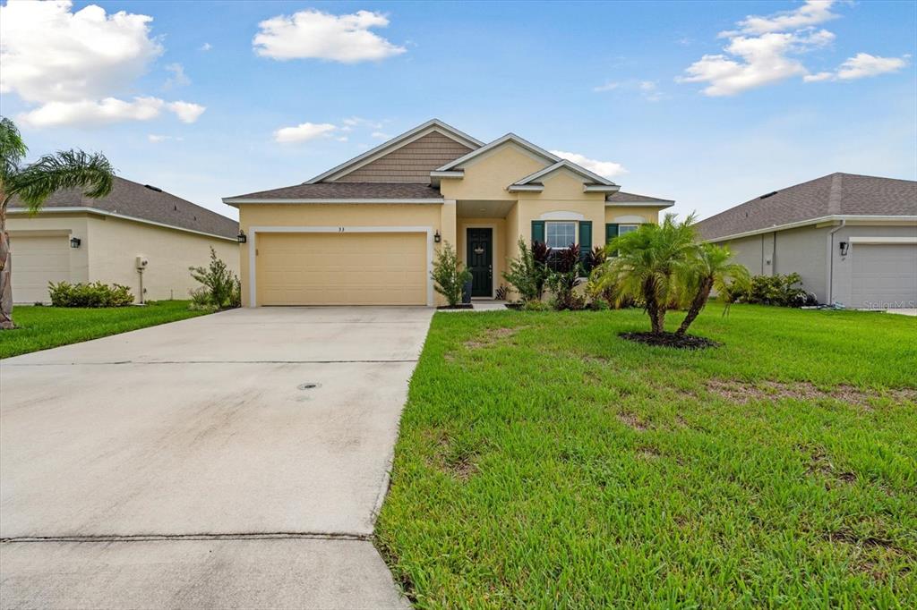 33 Ridge Road Palm Coast, FL 32137 - Photo 21 of 31 a front view of a house with a yard and garage