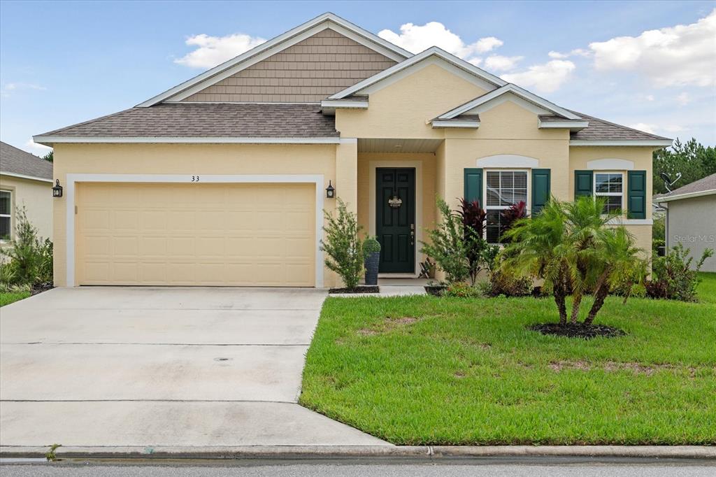 33 Ridge Road Palm Coast, FL 32137 - Photo 24 of 31 front view of house with a yard