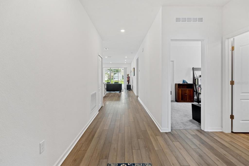 33 Ridge Road Palm Coast, FL 32137 - Photo 4 of 31 a view of a hallway with wooden floor and closet
