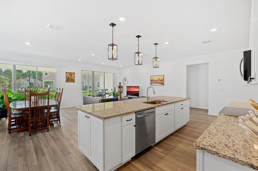 33 Ridge Road Palm Coast, FL 32137 - Photo 5 of 31 a large white kitchen with lots of counter space and furniture