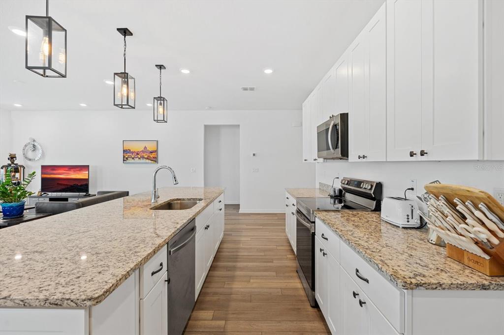 33 Ridge Road Palm Coast, FL 32137 - Photo 6 of 31 a kitchen with granite countertop a sink and counter top space