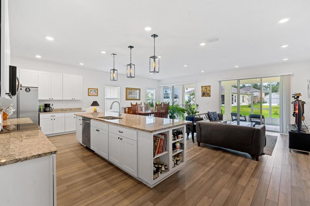 33 Ridge Road Palm Coast, FL 32137 - Photo 9 of 31 a kitchen with stainless steel appliances granite countertop a stove and a wooden floors