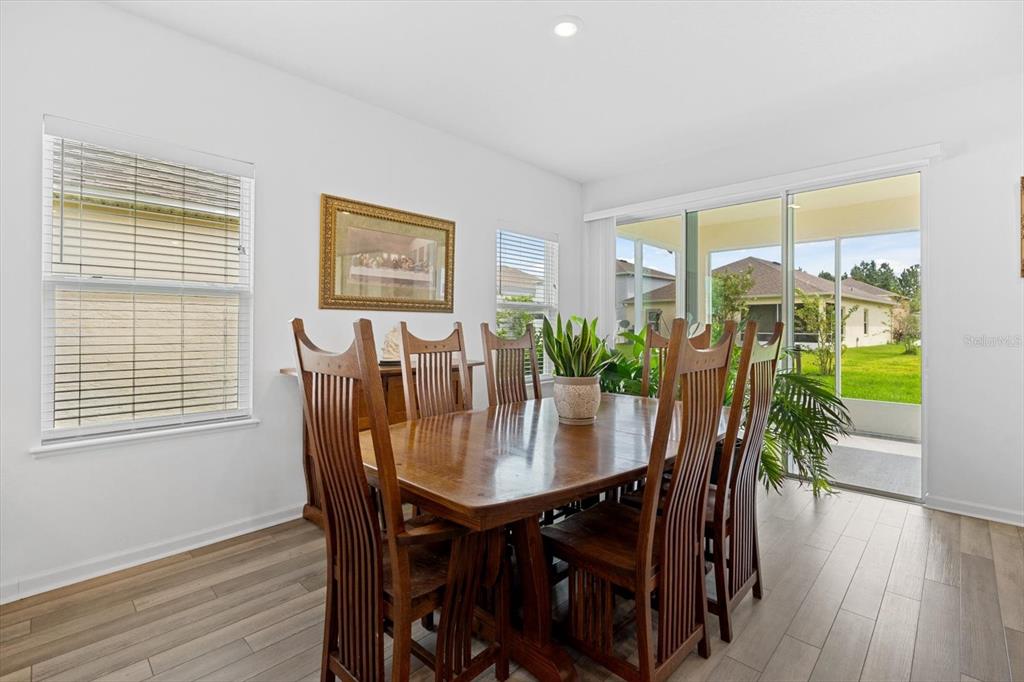 33 Ridge Road Palm Coast, FL 32137 - Photo 10 of 31 a view of a dining room with furniture window and wooden floor