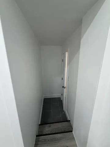 a view of a closet and wooden floor