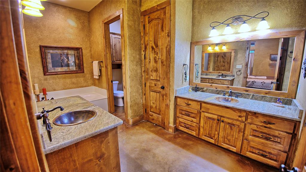 4509 Lazy E Road St. Jo, TX 76265 - Photo 31 of 39 a bathroom with a sink and a mirror