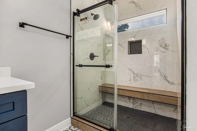 a bathroom with a sink vanity and mirror