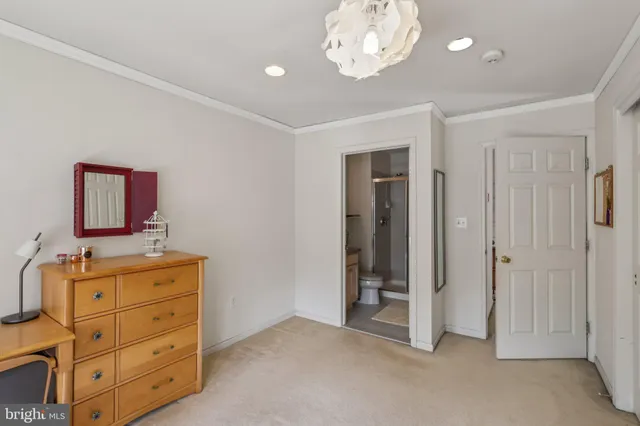 a bathroom with a granite countertop sink mirror vanity and toilet