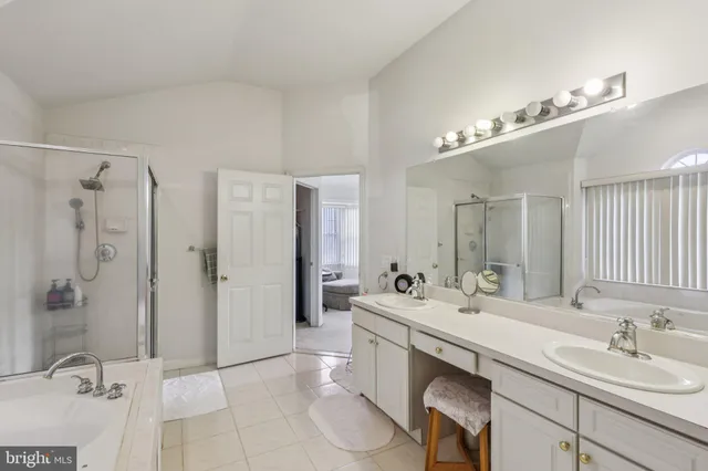 a bathroom with a tub a sink and mirror