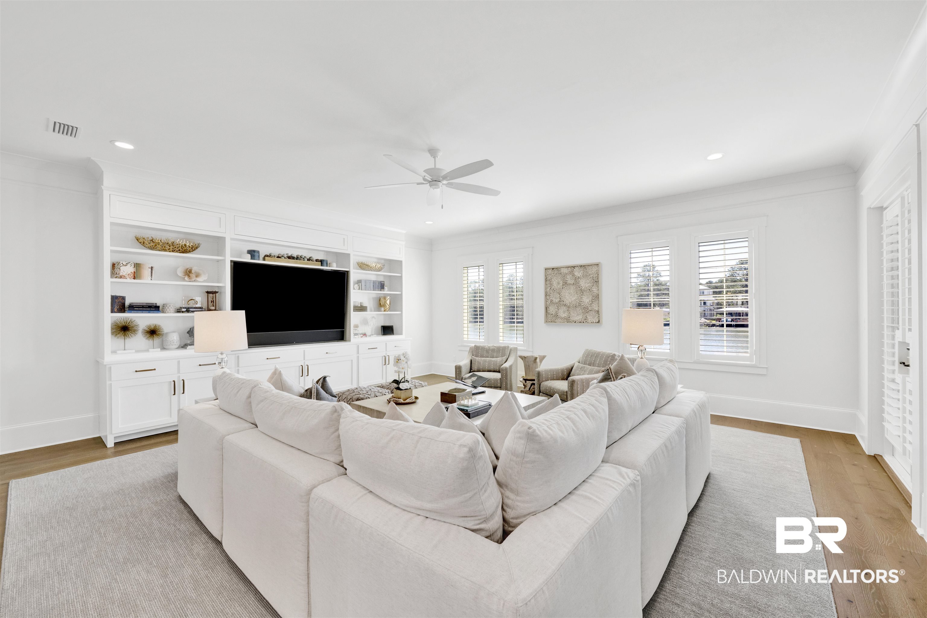 861 Inlet Circle Gulf Shores, AL 36542 - Photo 13 of 54 Living room with light wood finished floors, a ceiling fan, recessed lighting, ornamental molding, and built in features