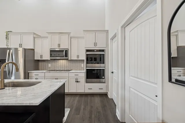 a kitchen with stainless steel appliances a refrigerator stove and microwave