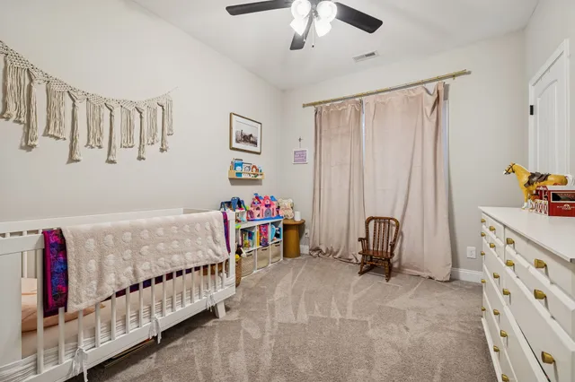 a bedroom with furniture and baby crib
