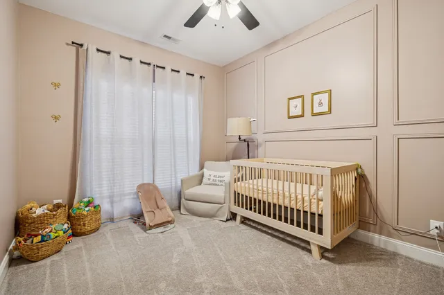 a bed room with a bed and a chair