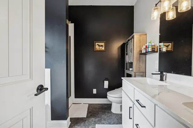 a bathroom with a bathtub and next to a window