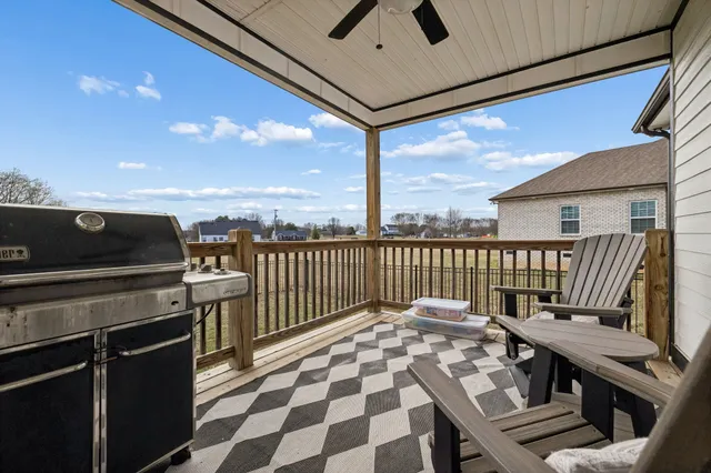 a balcony with table and chairs