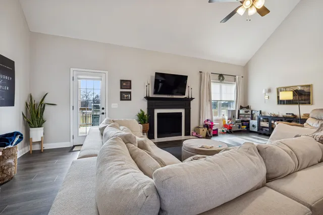 a living room with furniture a flat screen tv and a fireplace