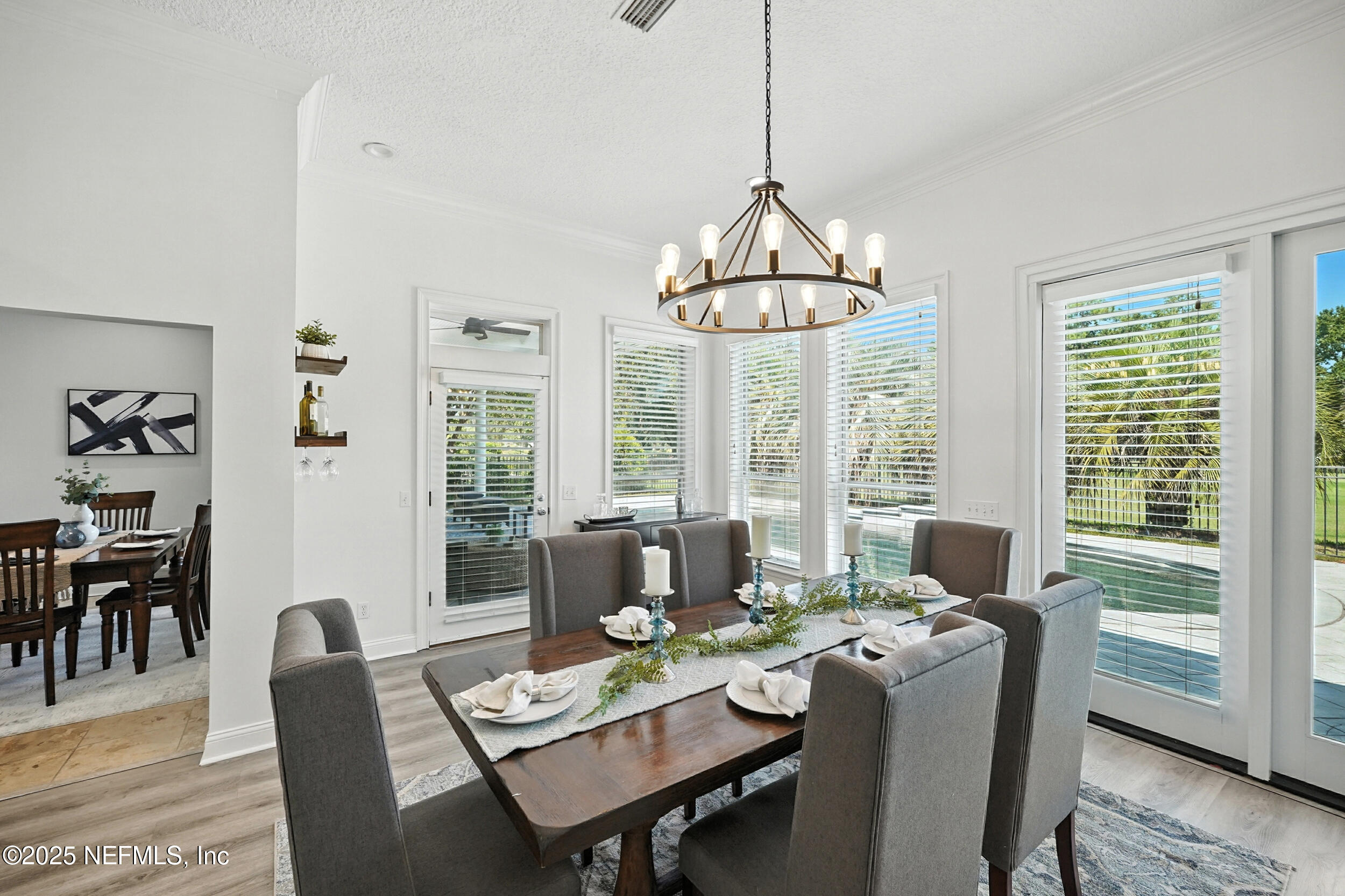 3743 Cricket Cove Road East Jacksonville, FL 32224 - Photo 14 of 55 a dining room with furniture a chandelier and wooden floor