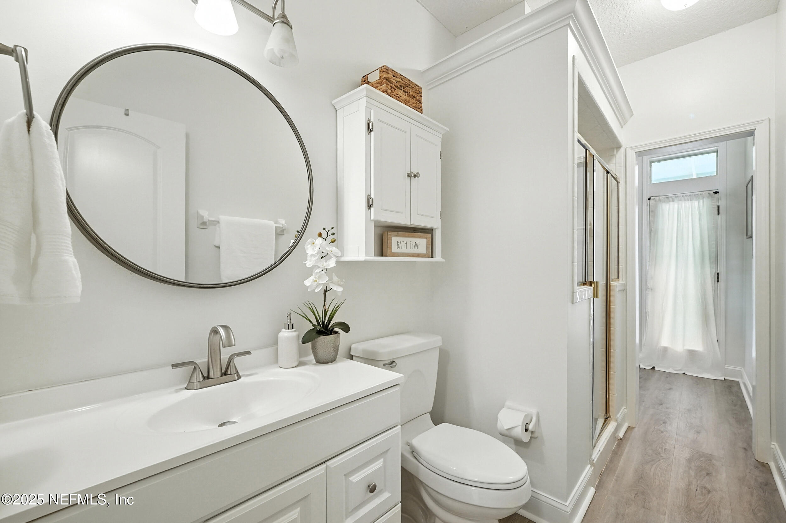 3743 Cricket Cove Road East Jacksonville, FL 32224 - Photo 25 of 55 a bathroom with a sink a mirror a toilet and a shower