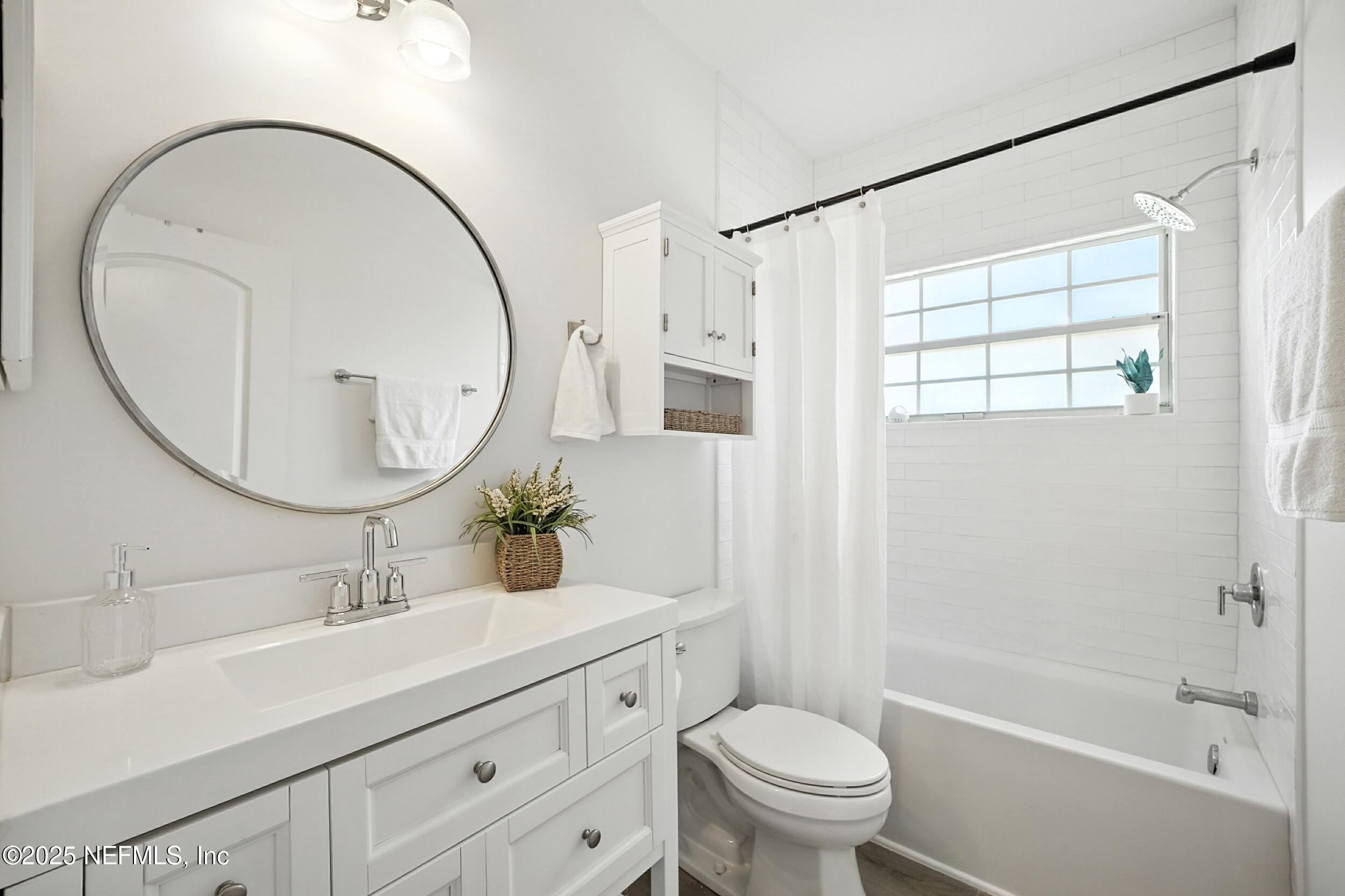 3743 Cricket Cove Road East Jacksonville, FL 32224 - Photo 29 of 55 a bathroom with a sink a mirror a toilet and a shower