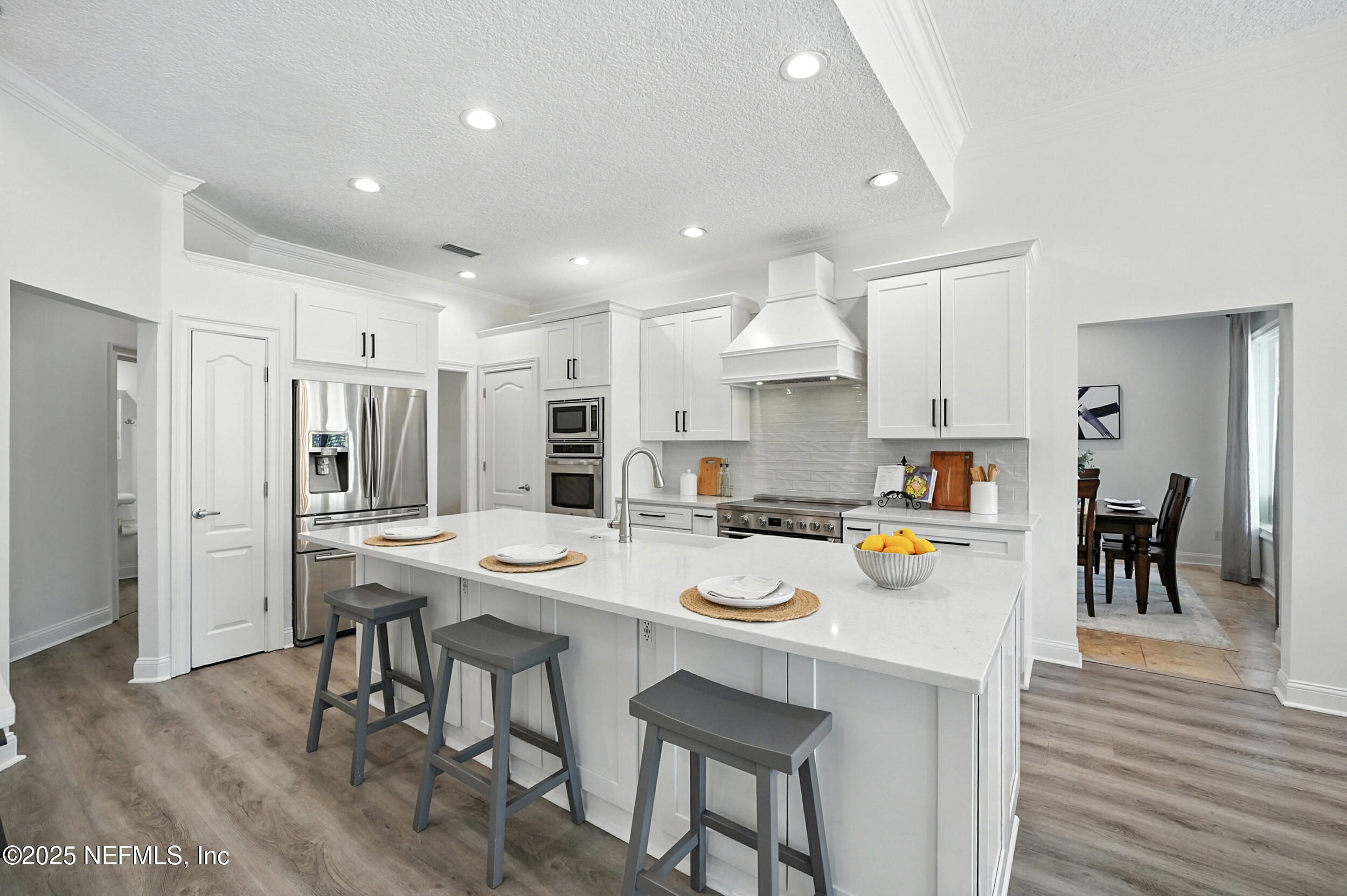 3743 Cricket Cove Road East Jacksonville, FL 32224 - Photo 8 of 55 a kitchen with a dining table chairs stove refrigerator and cabinets
