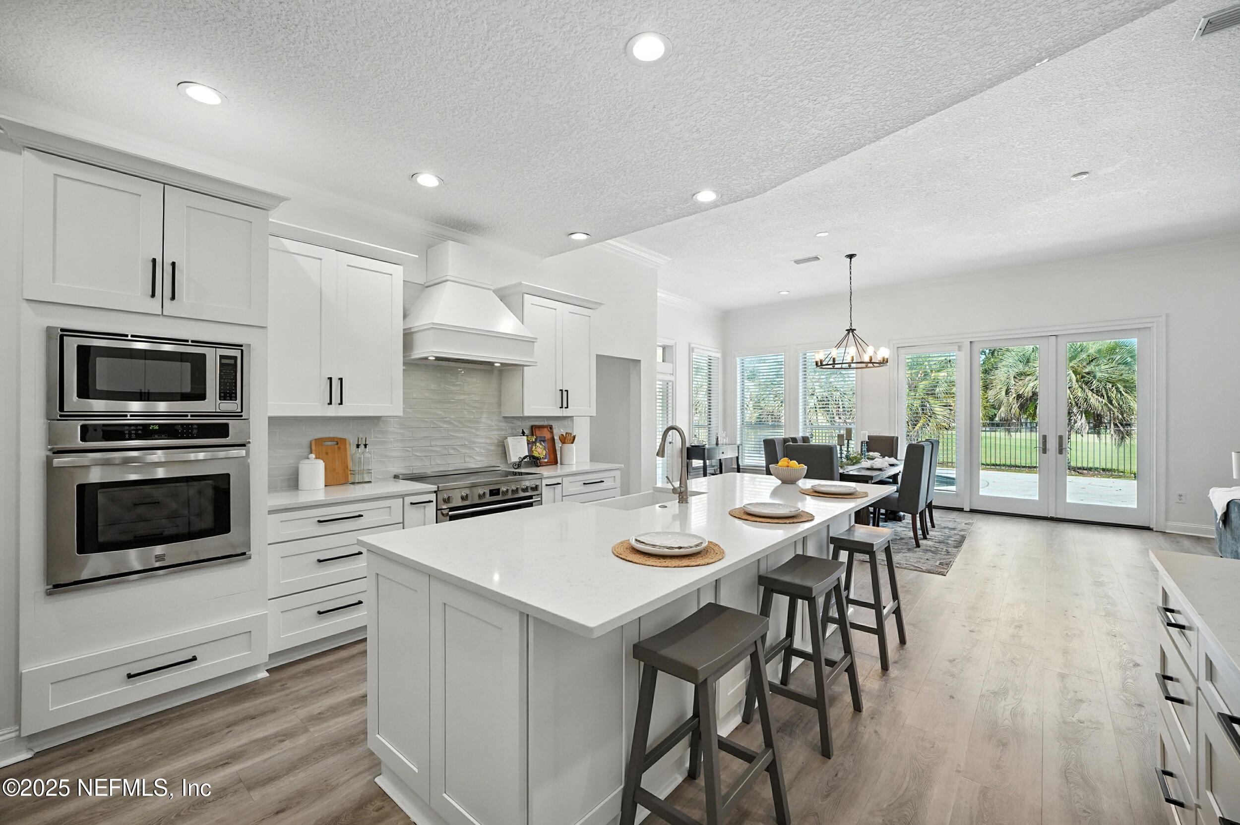 3743 Cricket Cove Road East Jacksonville, FL 32224 - Photo 9 of 55 a kitchen with a table chairs microwave and cabinets