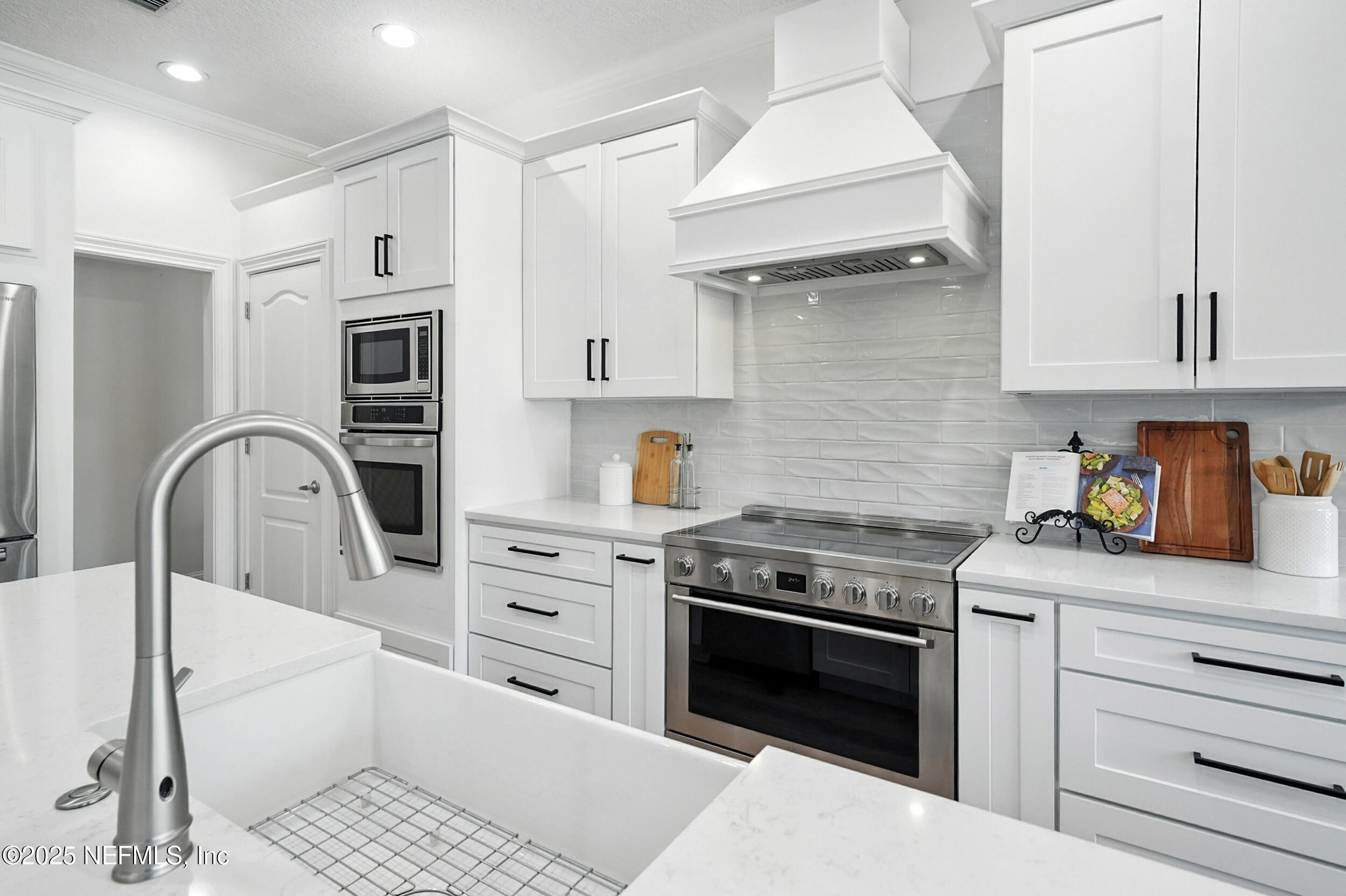 3743 Cricket Cove Road East Jacksonville, FL 32224 - Photo 10 of 55 a kitchen with stainless steel appliances granite countertop a stove and white cabinets