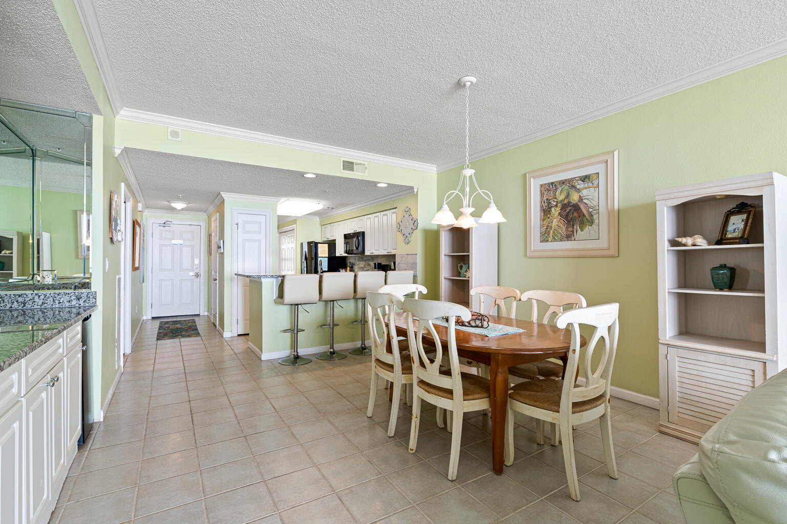 8499 Gulf Boulevard, Unit 303 Navarre, FL 32566 - Photo 11 of 52 a dining room with furniture and a view of kitchen