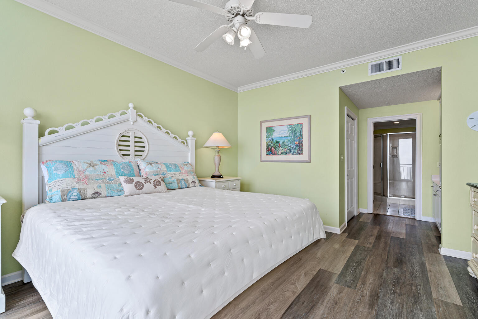 8499 Gulf Boulevard, Unit 303 Navarre, FL 32566 - Photo 14 of 52 a bedroom with a large bed and a chandelier