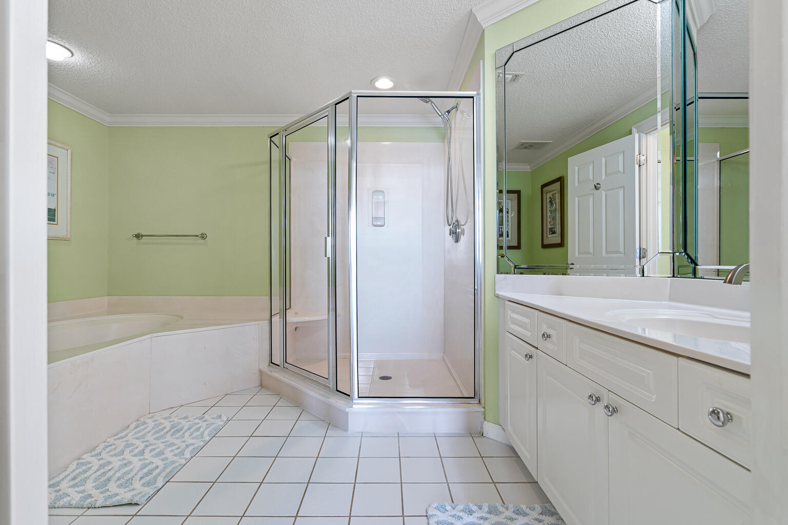 8499 Gulf Boulevard, Unit 303 Navarre, FL 32566 - Photo 18 of 52 a spacious bathroom with a granite countertop sink a mirror and a bathtub