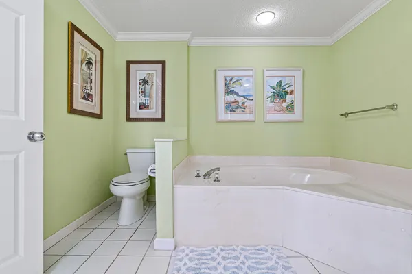 a bathroom with a granite countertop sink a toilet and a mirror